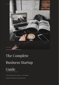 Business startup guide with laptop, coffee, and open book on desk